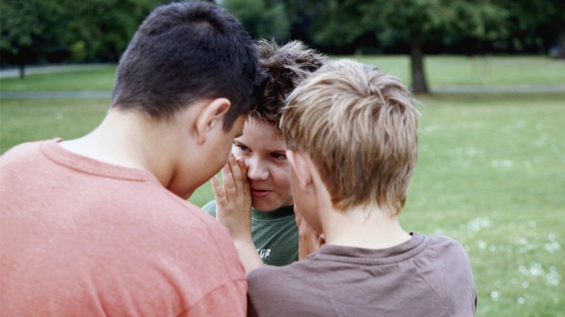 3 boys whispering